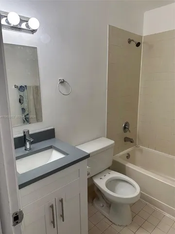 a bathroom with a sink toilet tub and shower