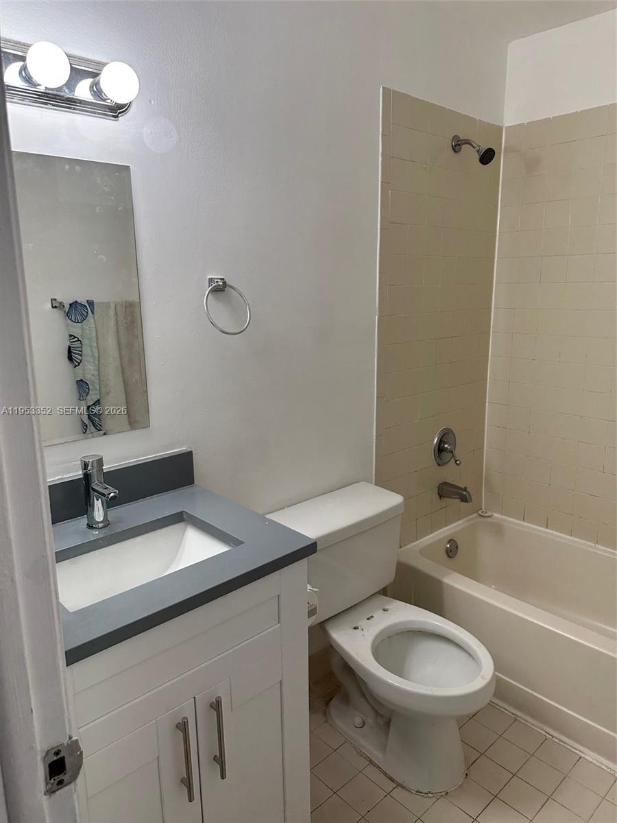 7155 Northwest 179th Street, Unit 304 Hialeah, FL 33015 - Photo 12 of 14 a bathroom with a sink toilet tub and shower