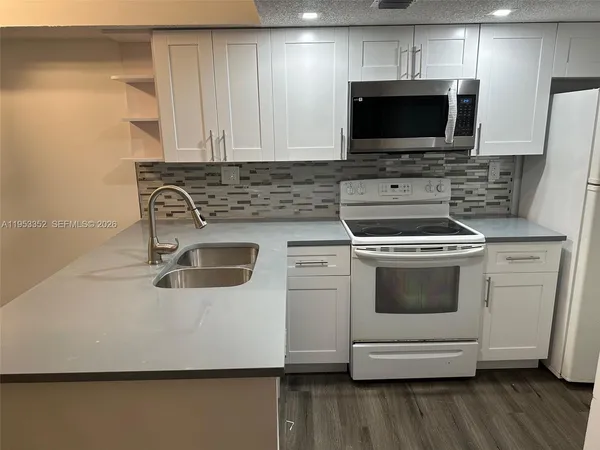 a kitchen with a stove and a microwave
