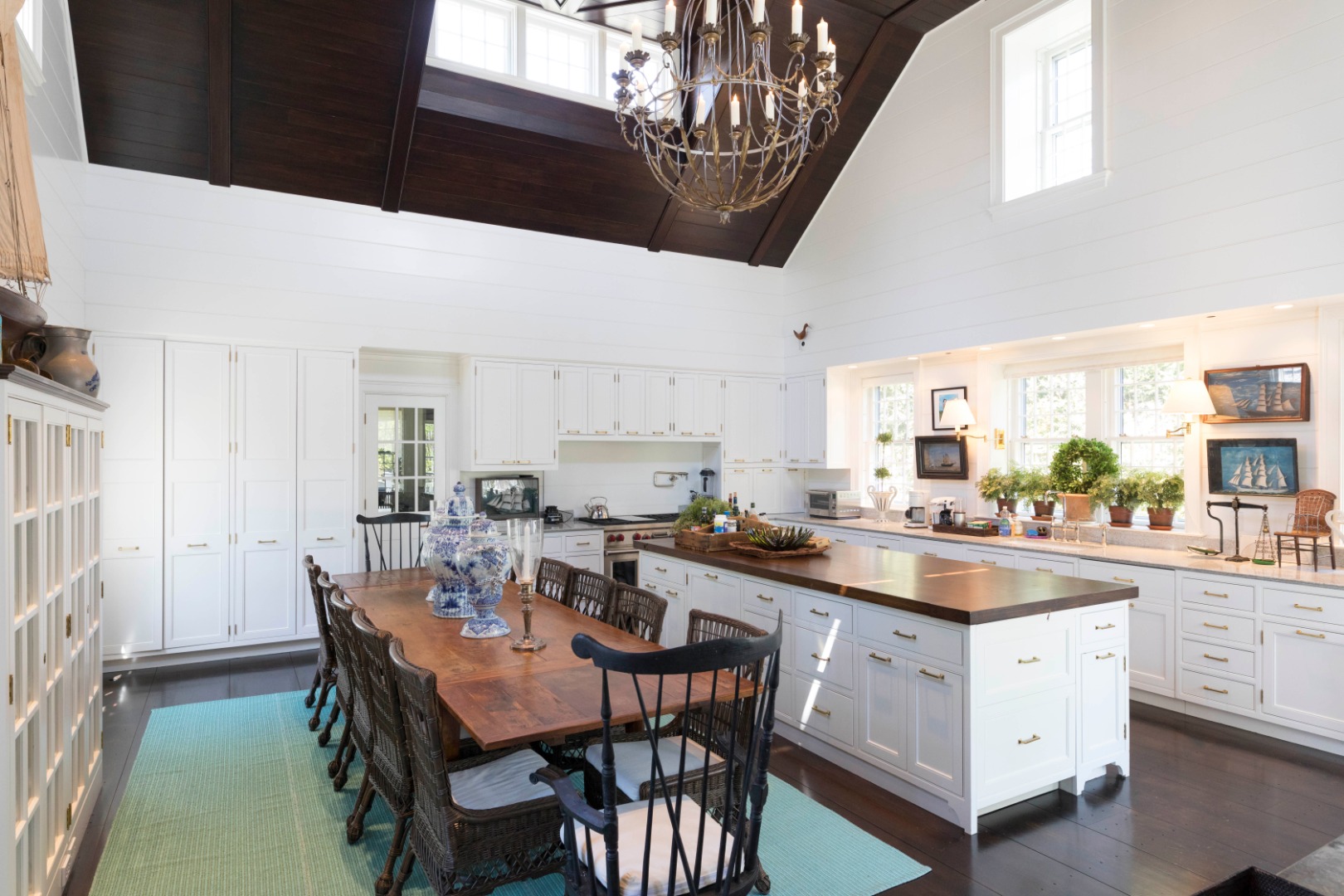 1 Twin Street Nantucket, MA 02554 - Photo 15 of 32 a kitchen with a dining table chairs and white cabinets