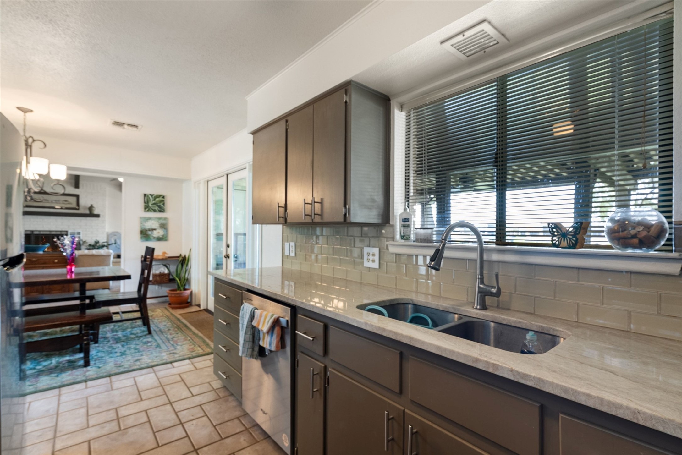 141 Perry Lane Kingsland, TX 78639 - Photo 23 of 40 A well-appointed kitchen features a deep sink and ample cabinetry, opening to a bright dining area.