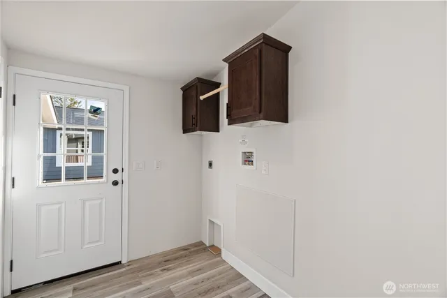 a view of a livingroom with wooden floor and cabinet