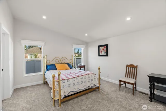 a bedroom with a bed and a couch