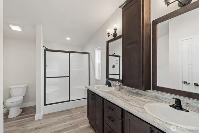 a spacious bathroom with a granite countertop sink and a mirror
