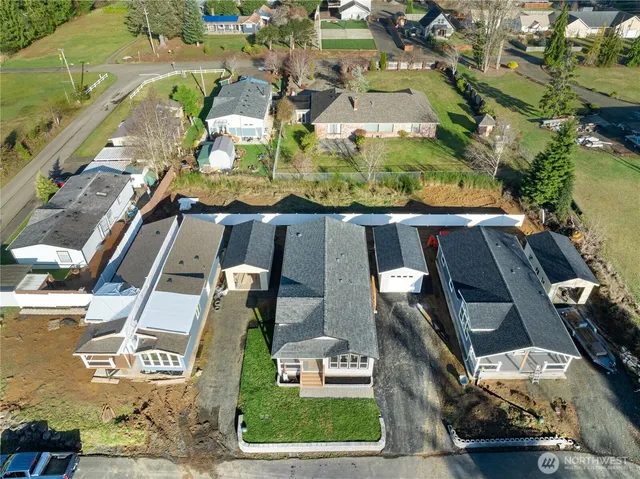 an aerial view of residential houses with outdoor space