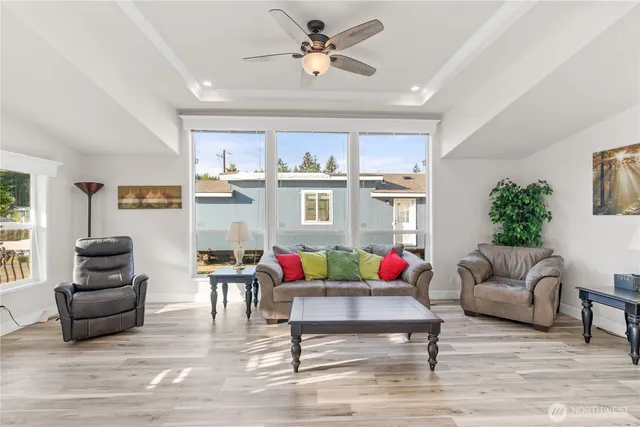 a living room with furniture and kitchen view
