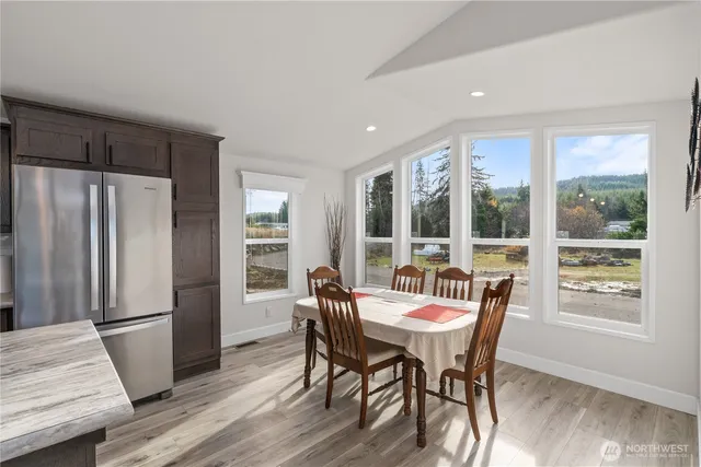a view of a dining room with furniture window and wooden floor