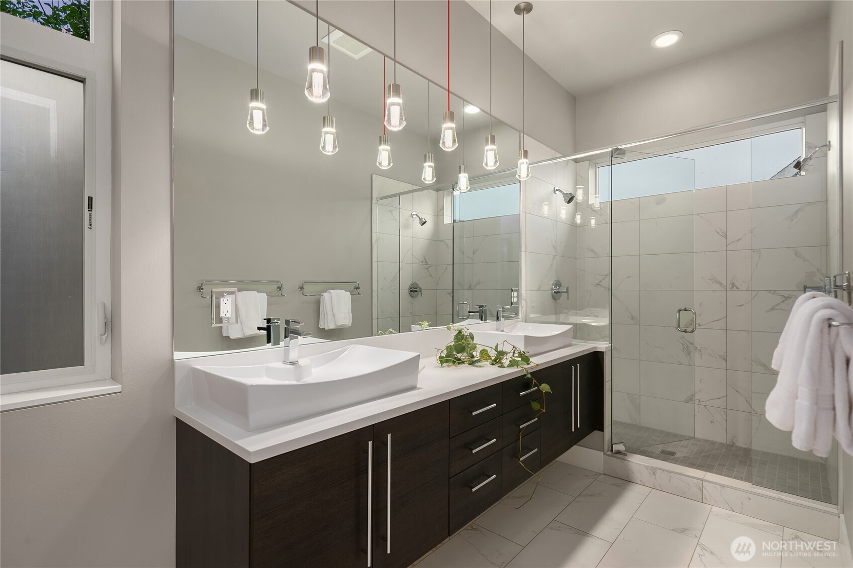 3501 Northwest 67th Street Seattle, WA 98117 - Photo 27 of 40 a bathroom with a double vanity sink mirror and shower