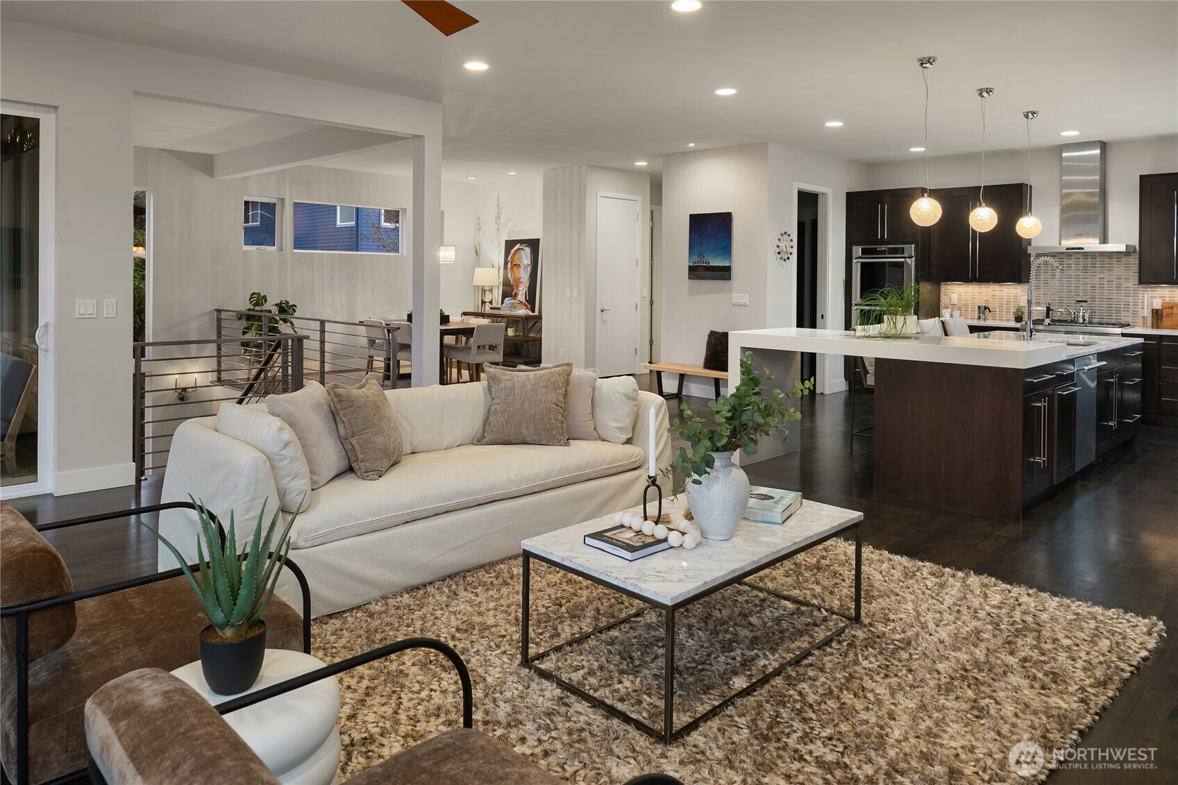 3501 Northwest 67th Street Seattle, WA 98117 - Photo 10 of 40 a living room with furniture kitchen view and a wooden floor