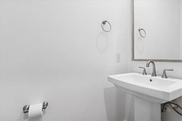 a bathroom with a sink and mirror