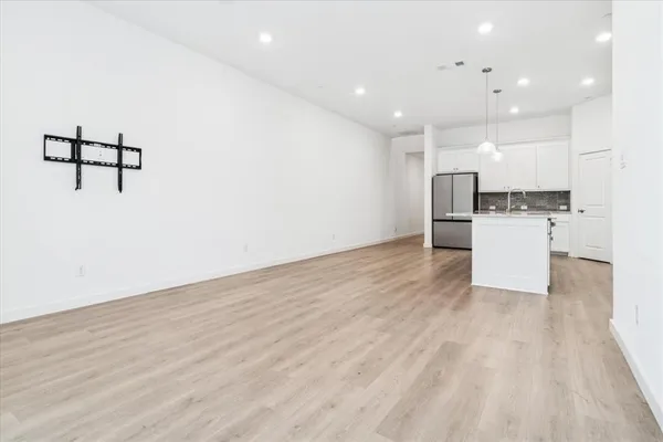 a view of a kitchen with a sink and a refrigerator