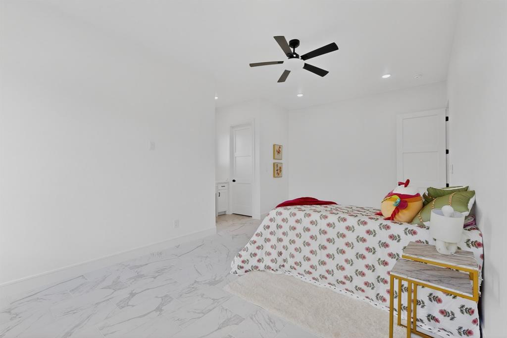 9080 County Road 669 Blue Ridge, TX 75424 - Photo 24 of 40 a bedroom with a bed and a chandelier