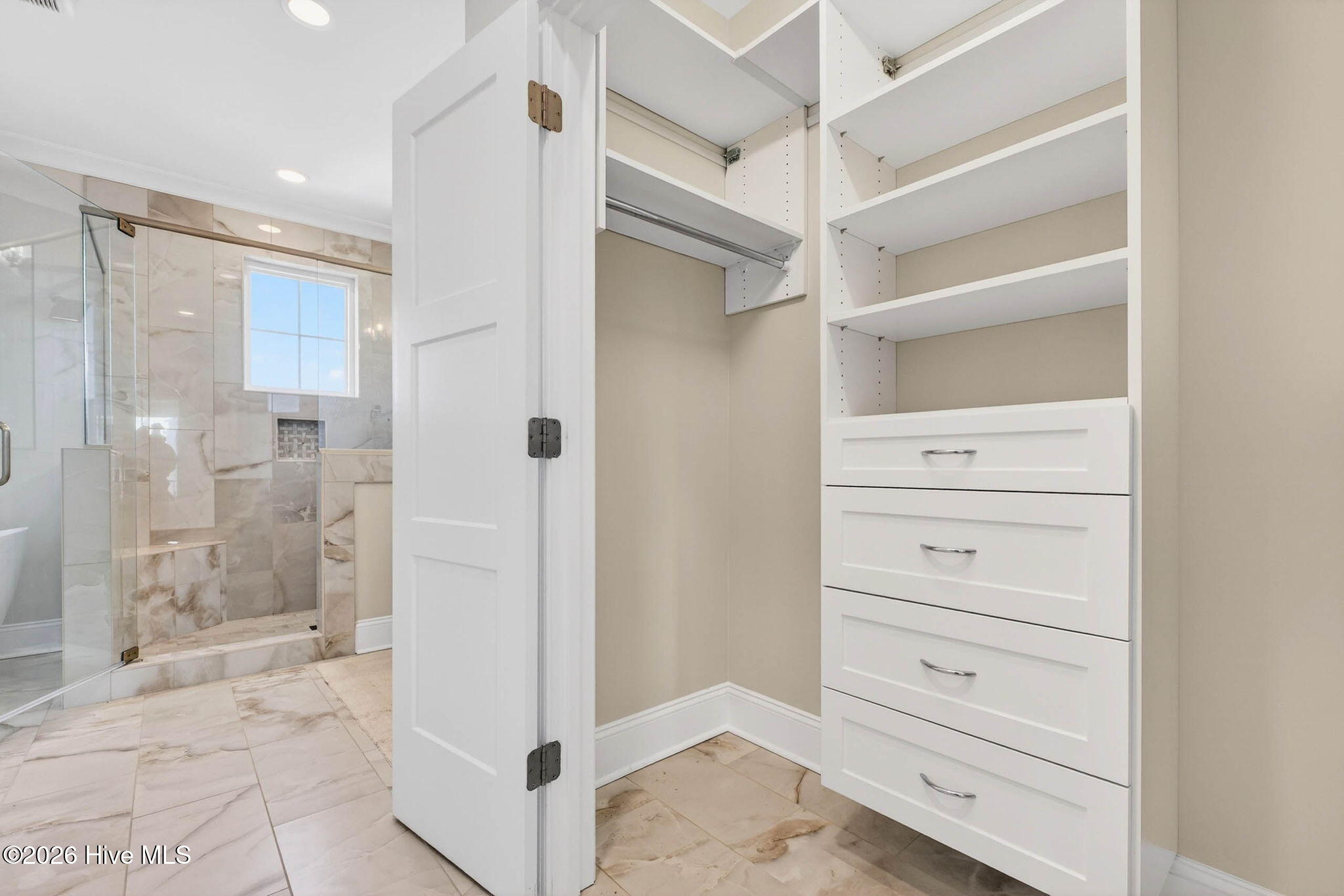 1416 Riverside Drive Sunset Beach, NC 28468 - Photo 38 of 83 Custom walk-in closet with built-in shelving and storage in this Sunset Beach coastal residence.