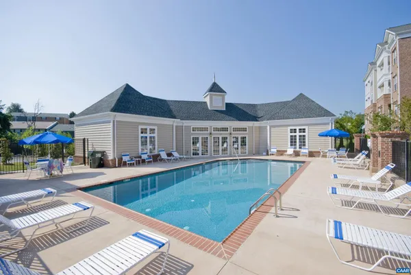 a view of house with swimming pool outdoor seating