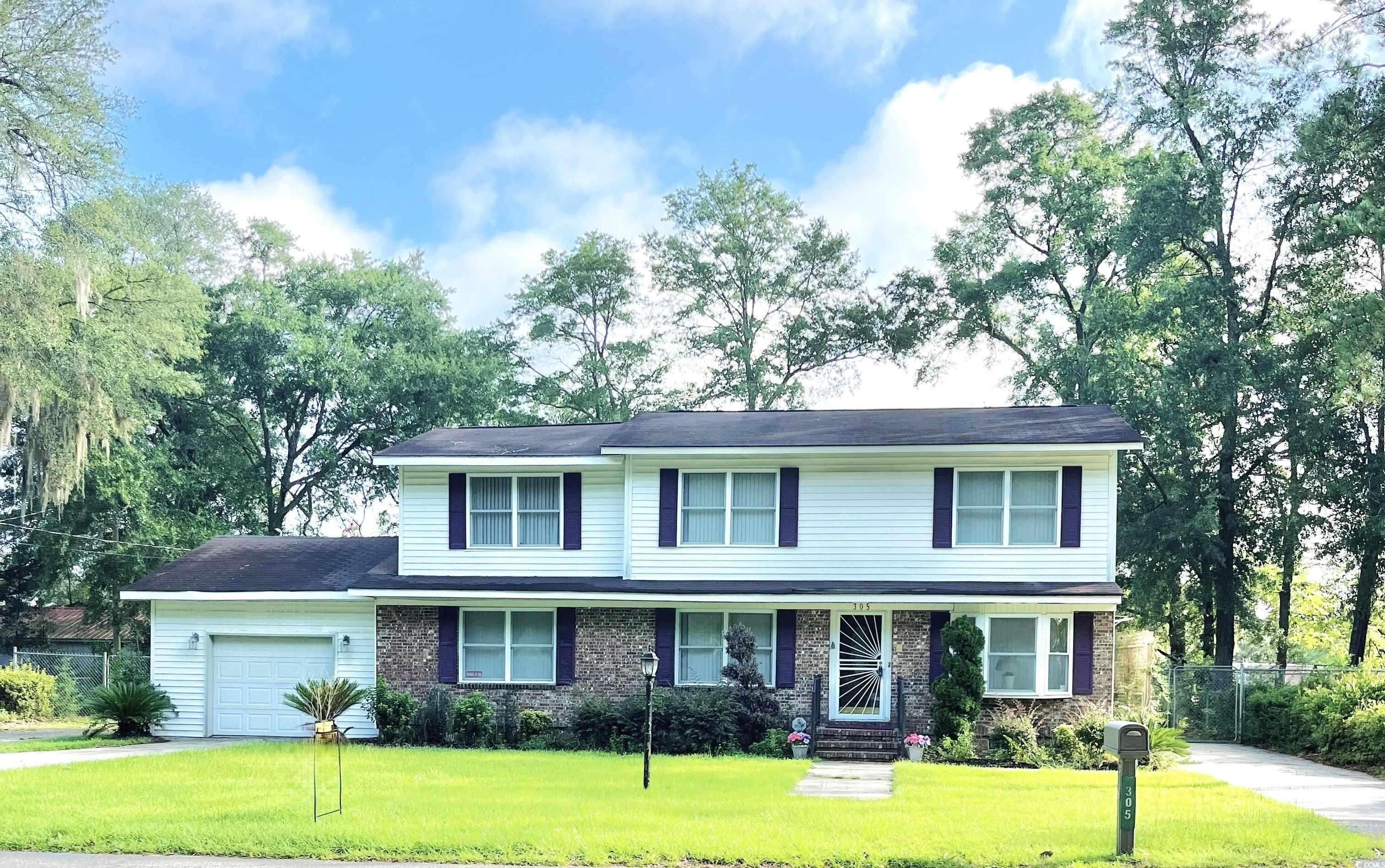 Traditional-style home with a garage and driveway