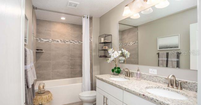 17625 Northwest 168th Road Alachua, FL 32615 - Photo 25 of 32 a bathroom with a granite countertop tub sink and mirror