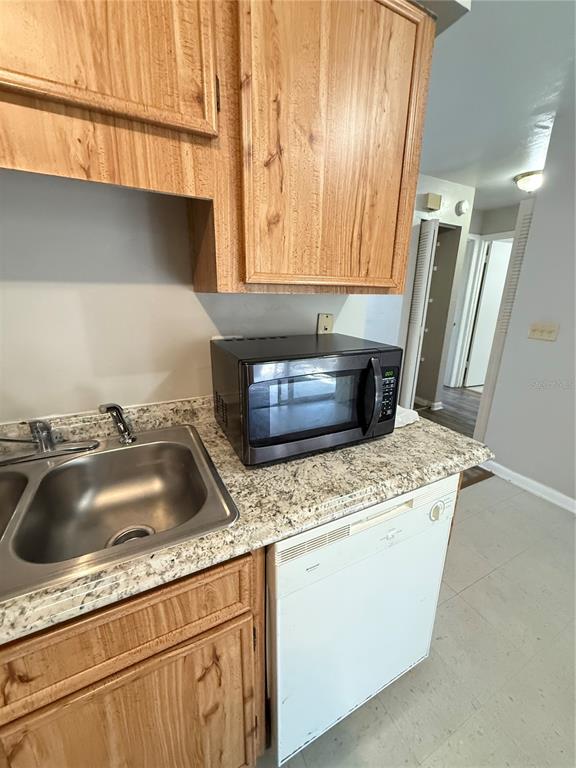 615 Southwest 11 Lane, Unit D Gainesville, FL 32601 - Photo 2 of 13 a kitchen with a sink and a refrigerator