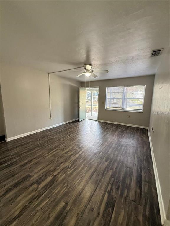 615 Southwest 11 Lane, Unit D Gainesville, FL 32601 - Photo 8 of 13 wooden floor in an empty room with a window