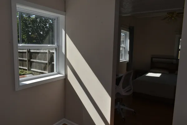 a bed room with a bed and a window