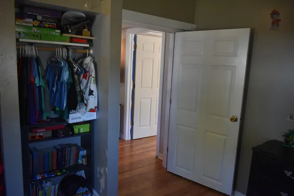 a room with a dresser and window