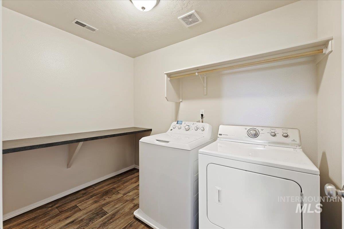 1555 Condor Drive Middleton, ID 83644 - Photo 37 of 50 Dedicated laundry room featuring wood-finish flooring, a built-in folding counter, and overhead shelving with a hanging rod