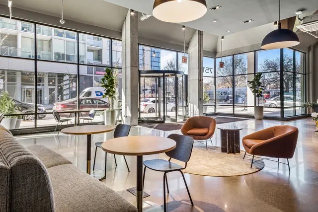 a dining room with furniture and a floor to ceiling window