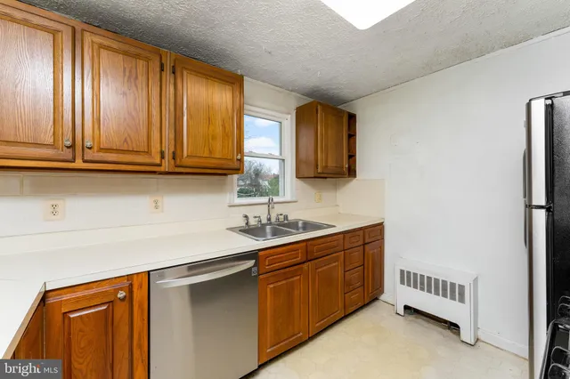 a kitchen with stainless steel appliances granite countertop a refrigerator stove and sink