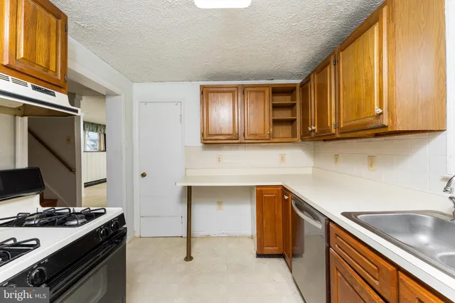 an empty room with chandelier fan