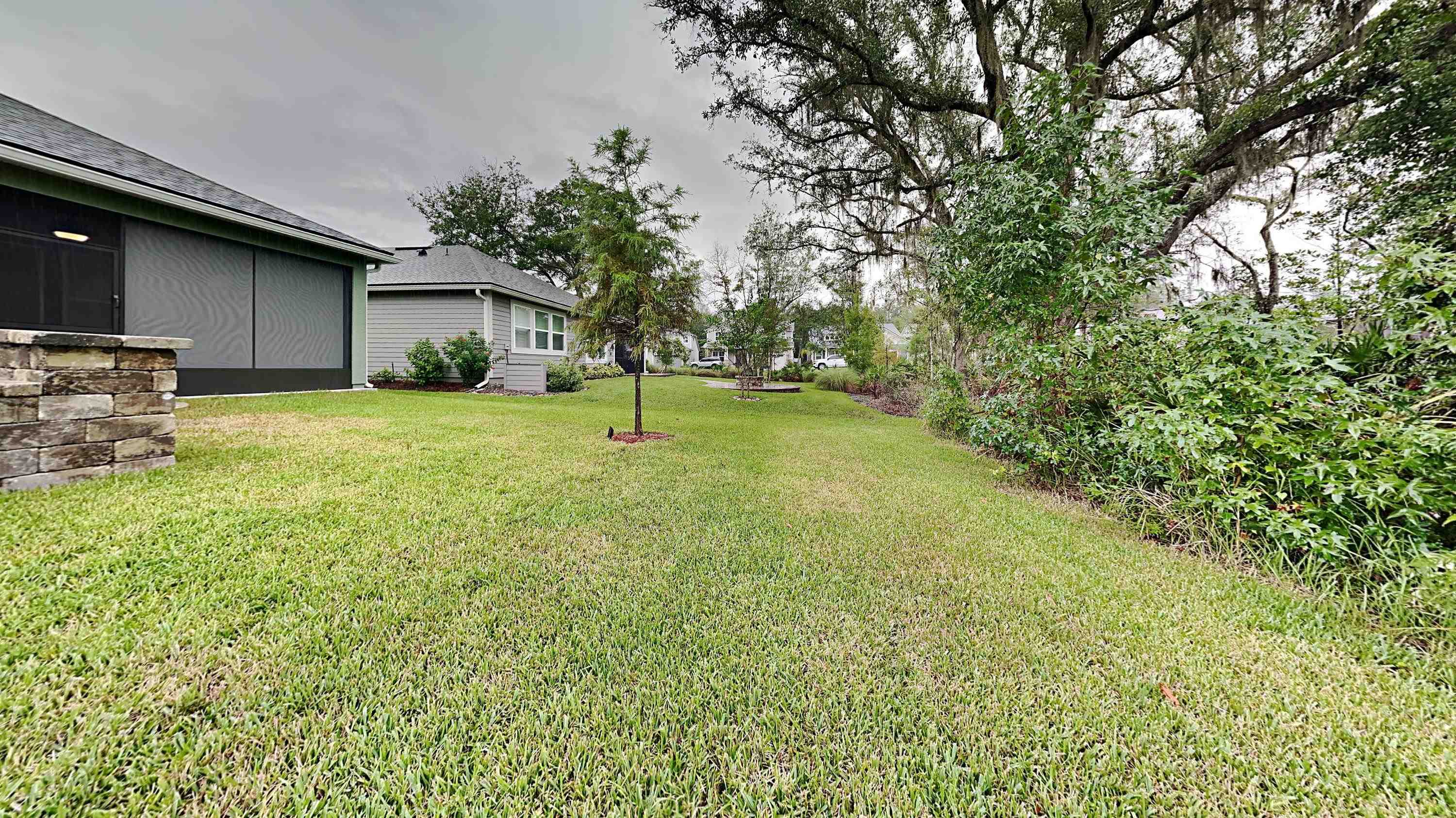 209 Cloverbrook Road St. Johns, FL 32259 - Photo 12 of 13 a tall house with a yard and large trees