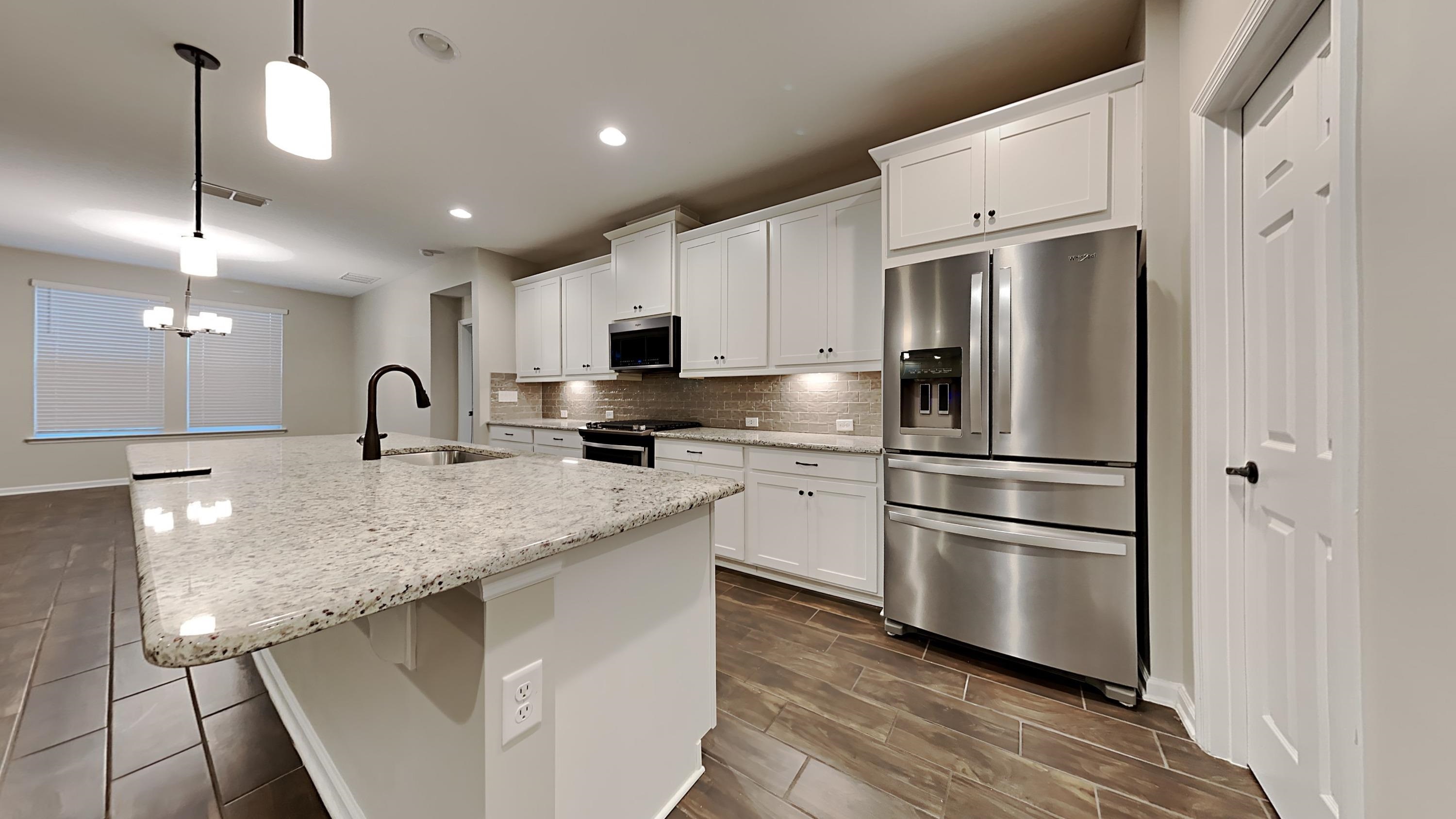 209 Cloverbrook Road St. Johns, FL 32259 - Photo 6 of 13 a kitchen with stainless steel appliances a refrigerator sink and microwave