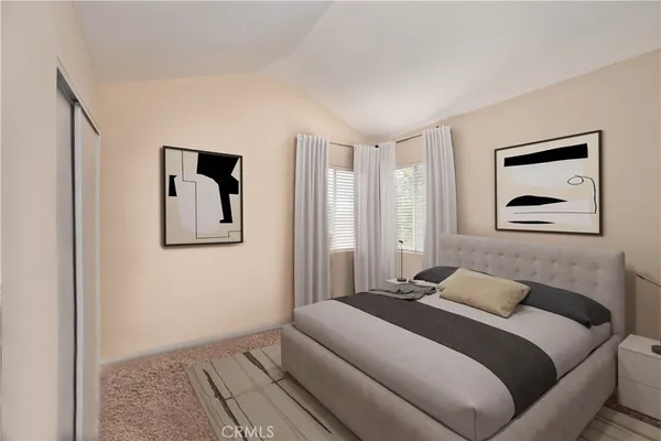 a bedroom with a bed and a painting on the wall