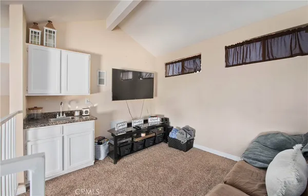 a bed room with furniture and a flat screen tv