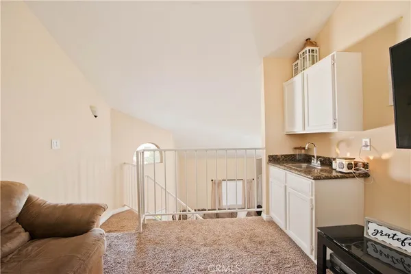 a view of a kitchen with furniture and a rug