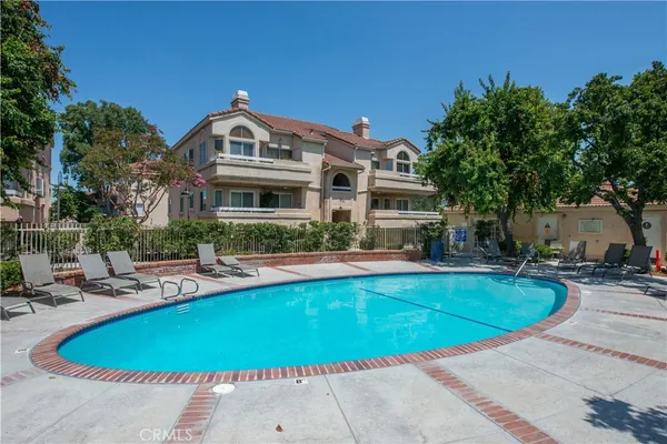 a view of a house with swimming pool and sitting area
