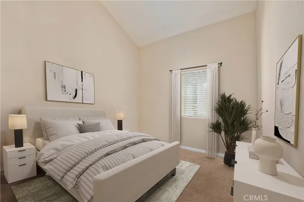 a bedroom with a large bed and a potted plant