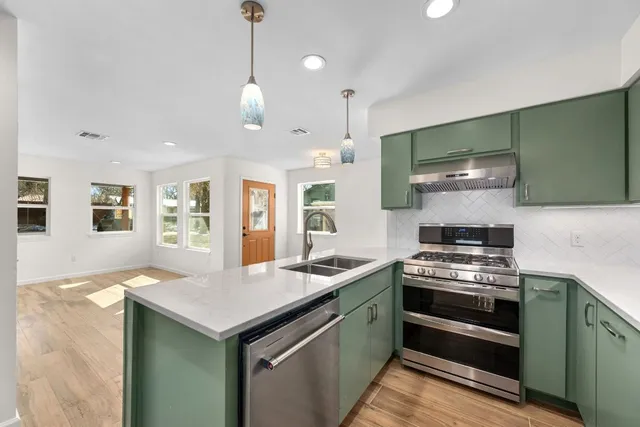 a kitchen with a stove and a sink