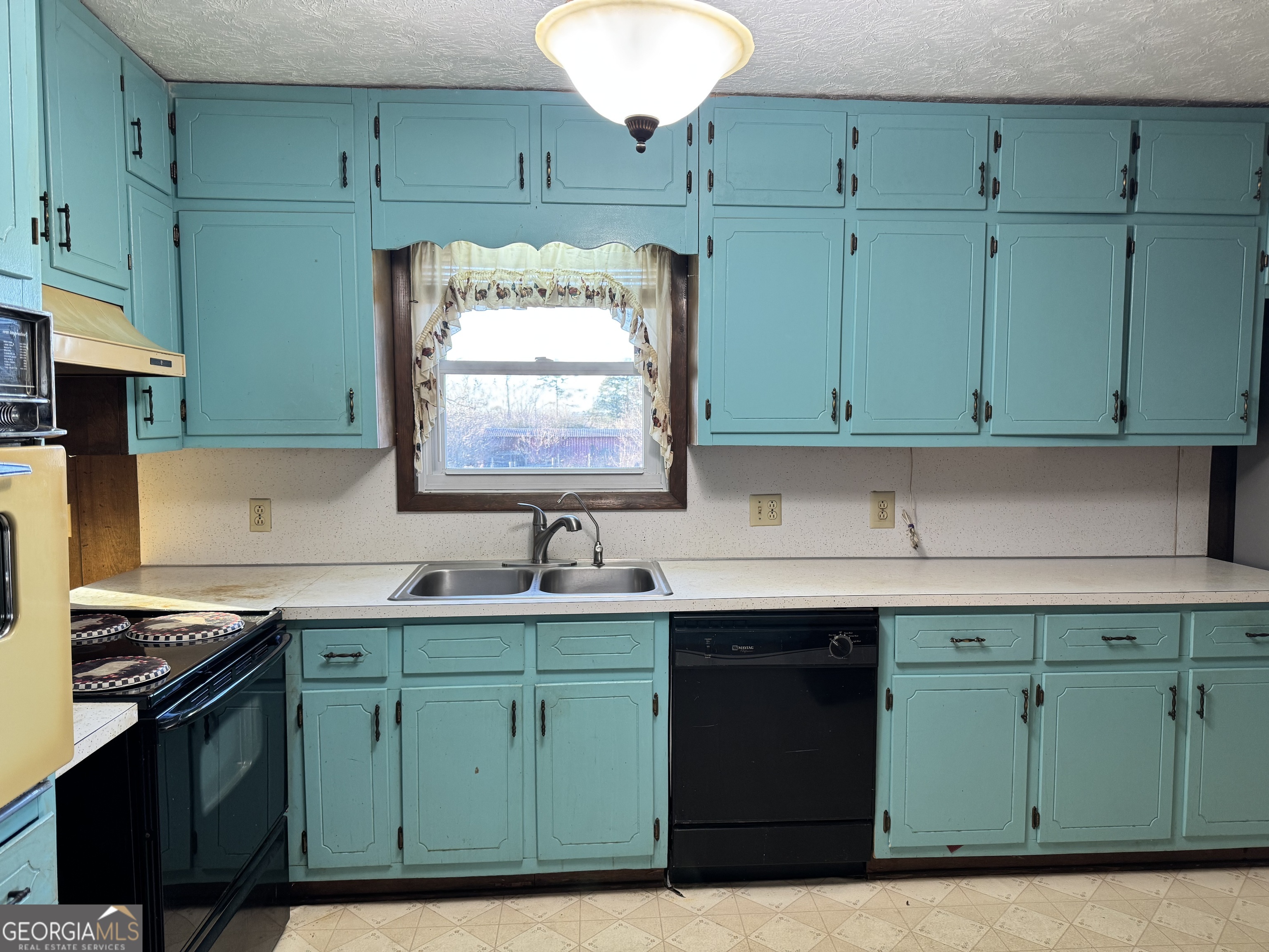 2324 Wilson Road Northwest Conyers, GA 30012 - Photo 5 of 13 a kitchen with a sink cabinets and a wooden floors