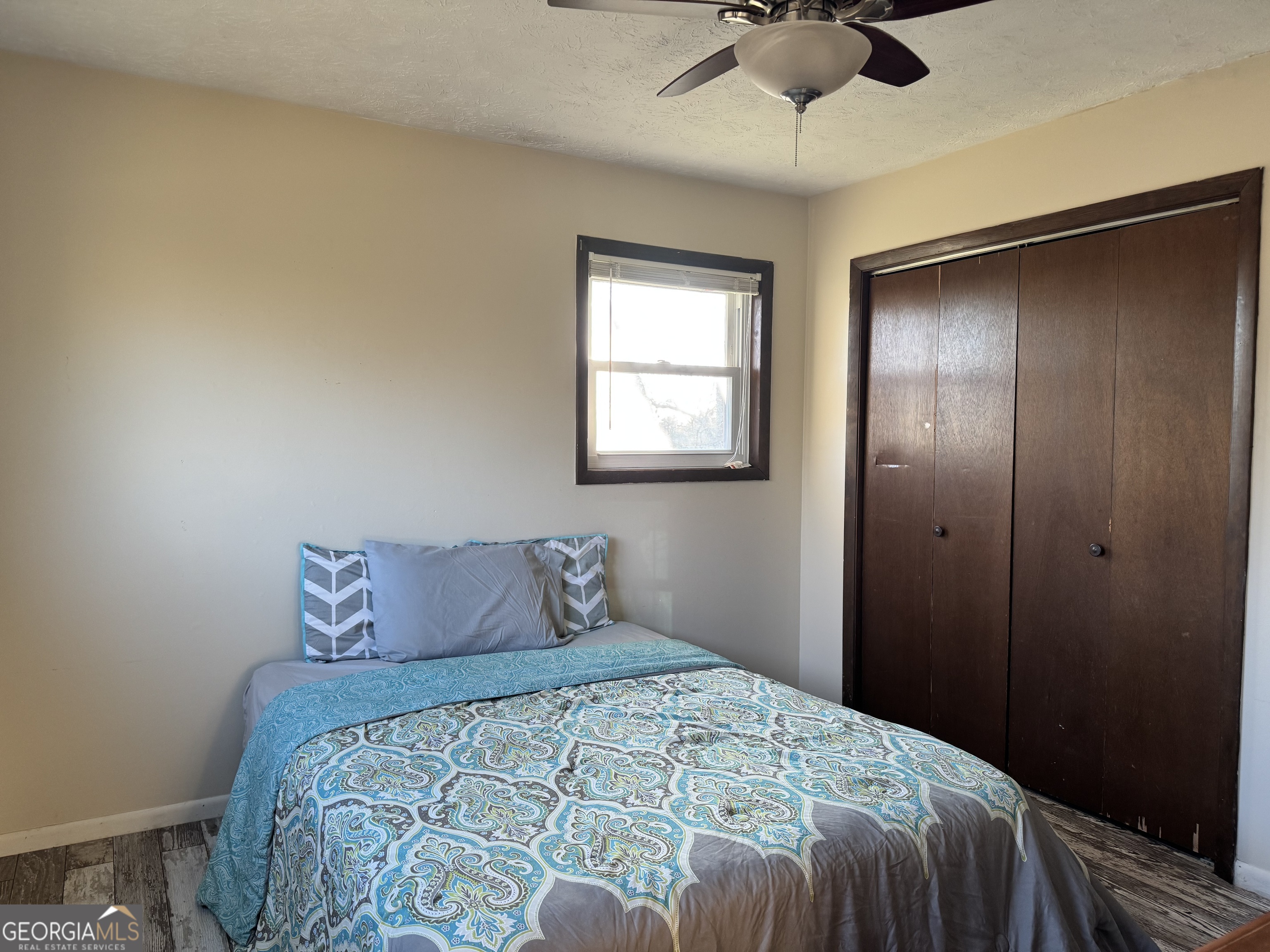2324 Wilson Road Northwest Conyers, GA 30012 - Photo 10 of 13 a bedroom with a bed and a chandelier