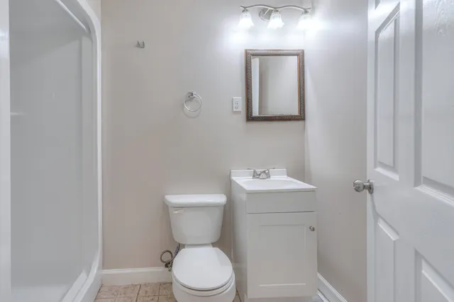 a white toilet sitting next to a bathroom sink