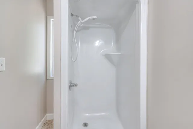 a bathroom with a glass shower door