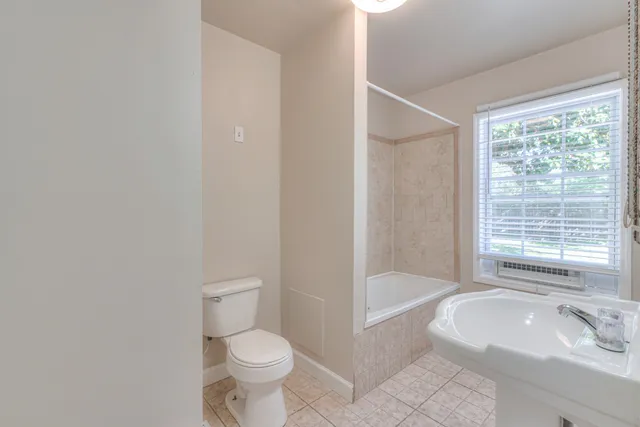 a bathroom with a tub toilet and sink