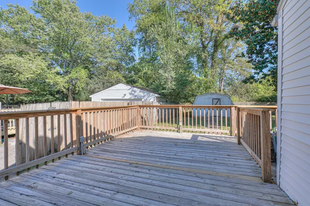 a balcony with wooden floor and fence
