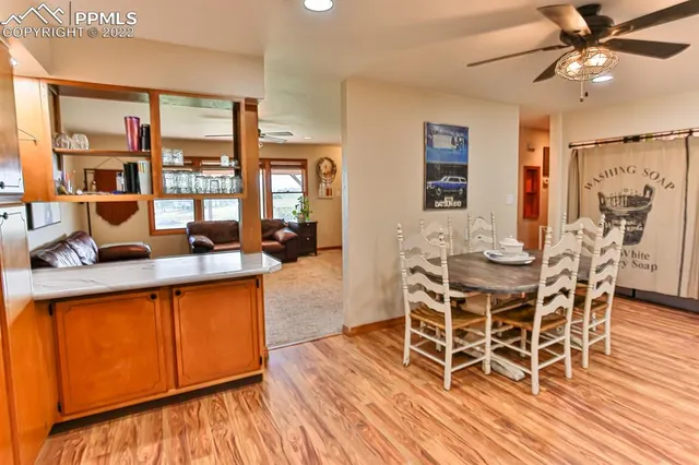 a kitchen with stainless steel appliances a table chairs and chandelier