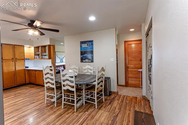 a kitchen with stainless steel appliances kitchen island granite countertop a stove top oven a sink and a wooden floors