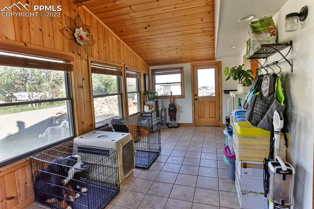 a living room with furniture a flat screen tv and large windows