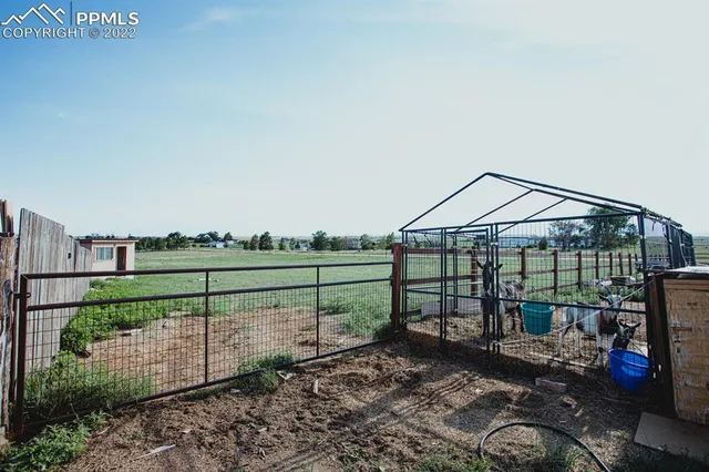 a view of a swimming pool with a patio and a yard