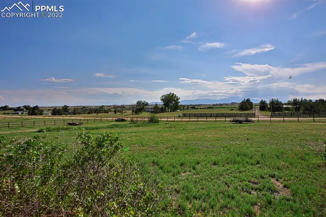 a kitchen with kitchen island granite countertop a refrigerator and a sink