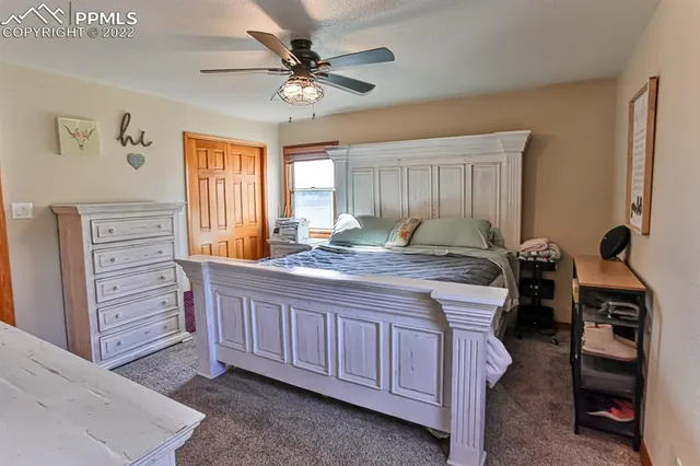 a bed room with a bed and a chandelier