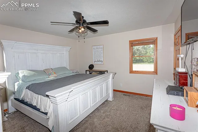 a bedroom with furniture and a flat screen tv