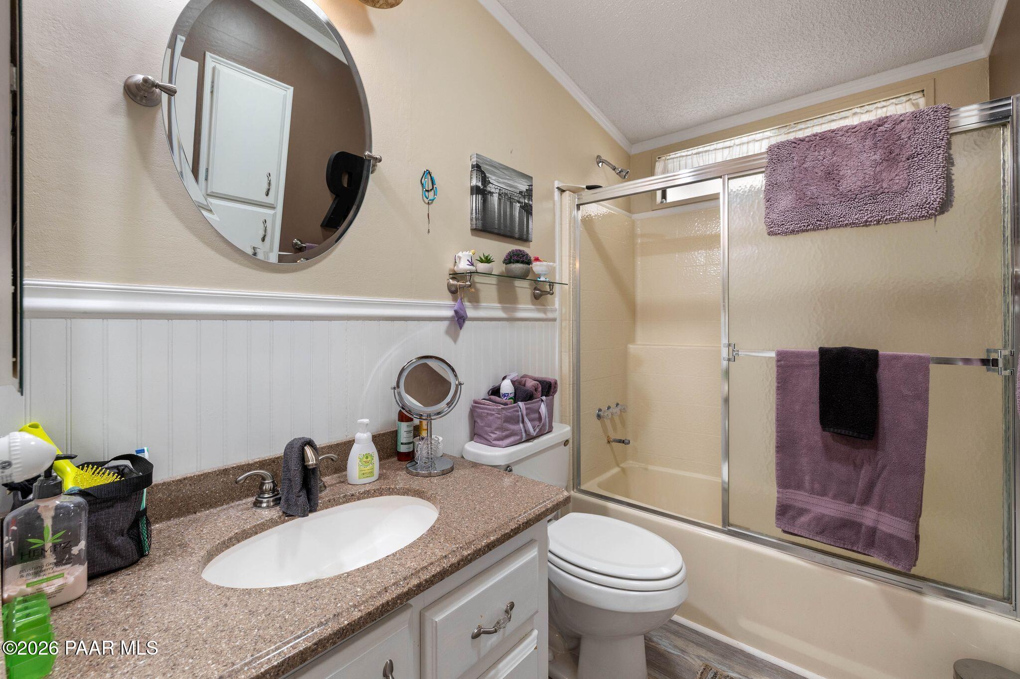 10194 East Durham Road Dewey, AZ 86327 - Photo 25 of 47 a bathroom with a granite countertop sink mirror vanity and toilet